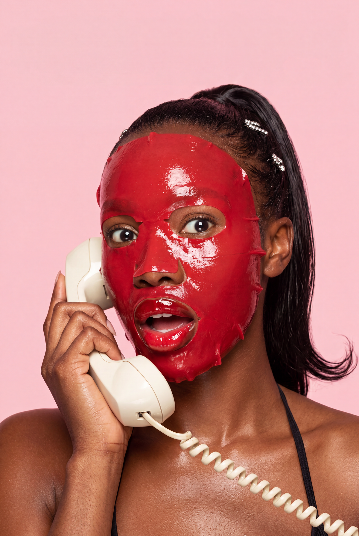 Woman with melanin-rich skin showing a hydrated, healthy glow wearing a Glamquest red hydrogel Korean skincare mask