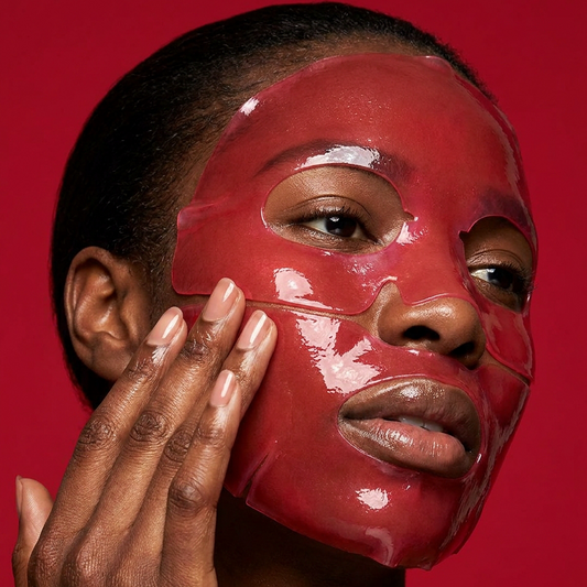 Woman applying Glamquest red hydrogel face mask, Korean skincare for melanin-rich skin